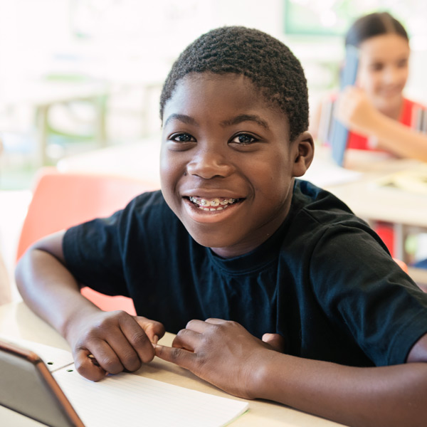young boy with braces in school