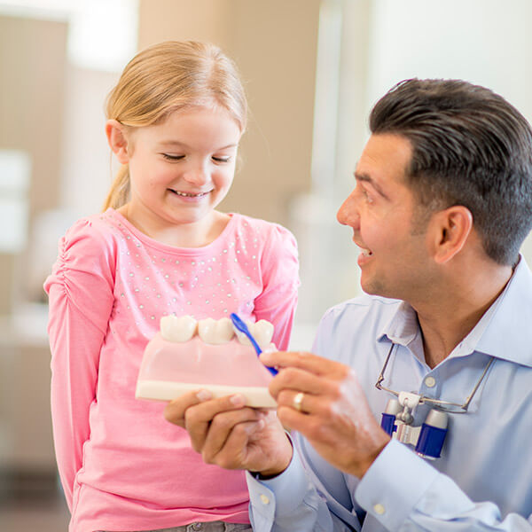 dentist talking to young patient